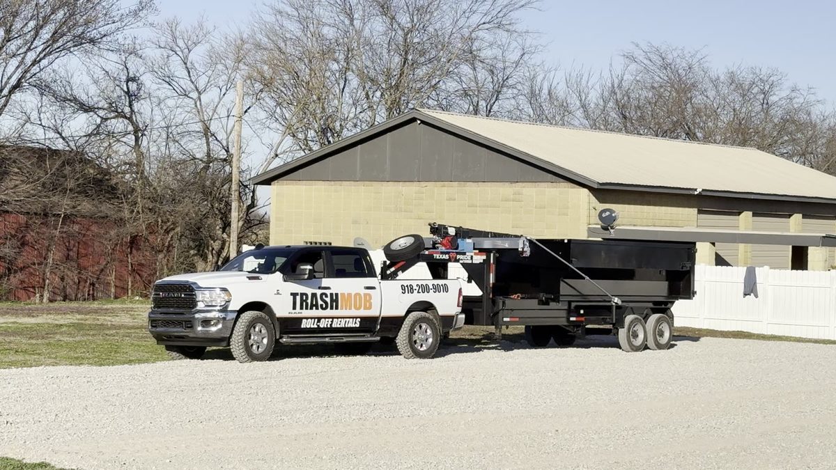 TrashMob truck delivering a roll-off dumpster