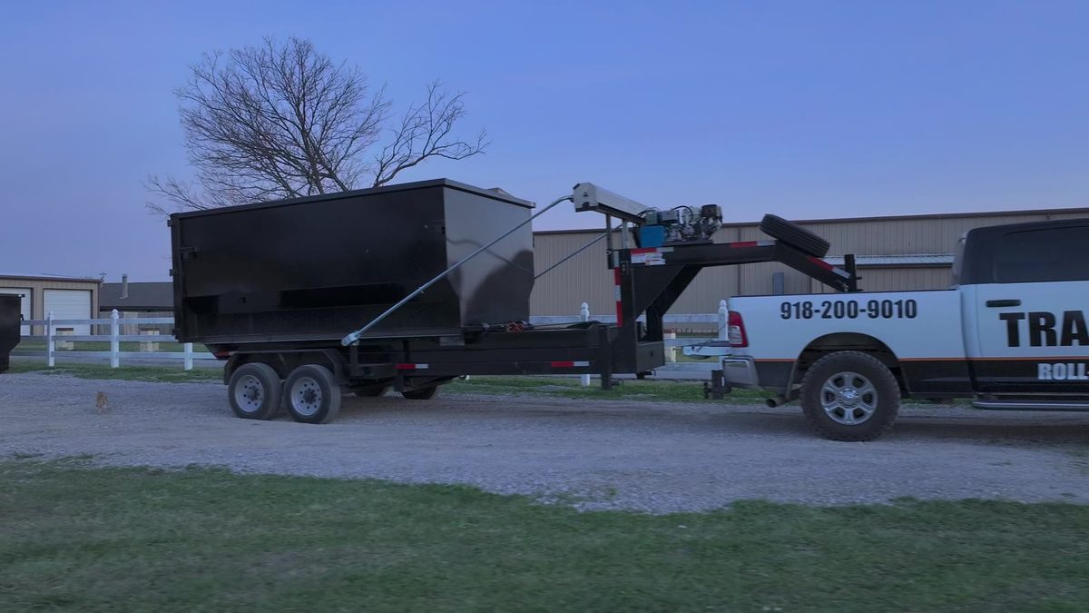 TrashMob truck towing a roll-off dumpster trailer for storm cleanup